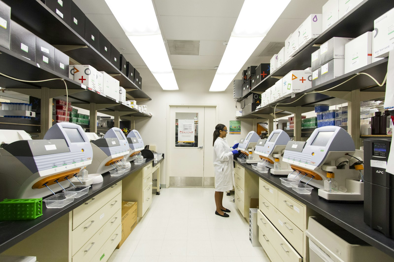 A bright, modern life-sciences laboratory lined with precision instruments